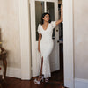 Bride in bridal luncheon dress with complimentary statement pearl jewelry. 