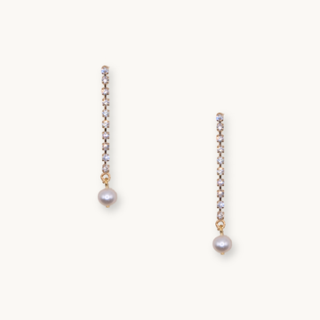 Elegant drop earrings with a row of sparkling diamonds ending in a single white pearl. The design conveys a sense of sophistication and timeless beauty.