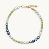 Green, blue, and white pearl necklace with a gold clasp on a white background.