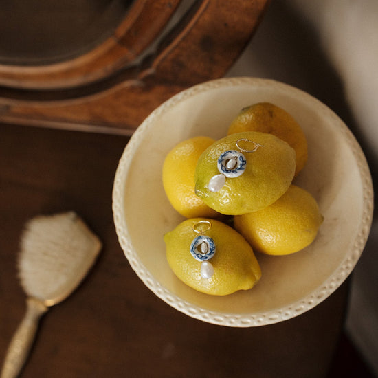 Decorative lemons with jewelry on a wooden surface