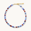 Multicolored beaded necklace with a gold clasp on a white background