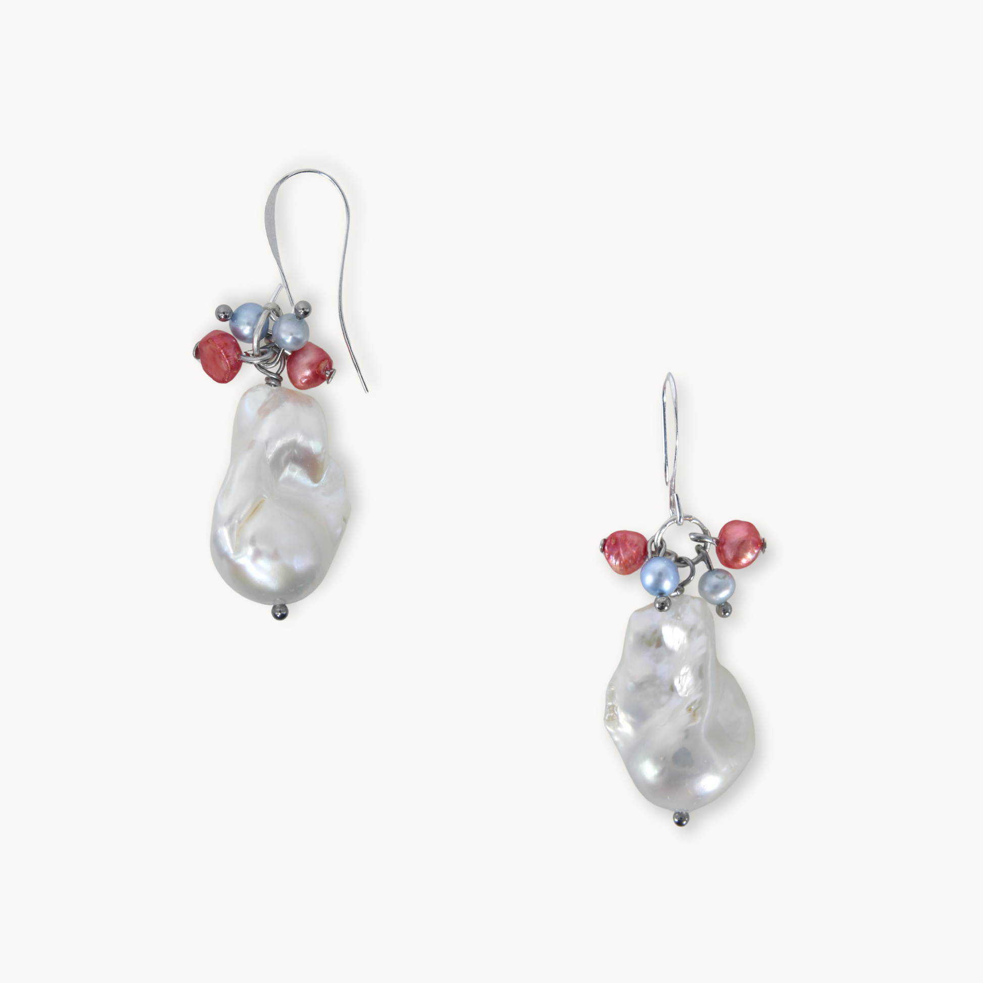Pair of pearl earrings with red and blue accents on a white background