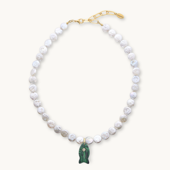 Pearl necklace with a green pendant on a white background