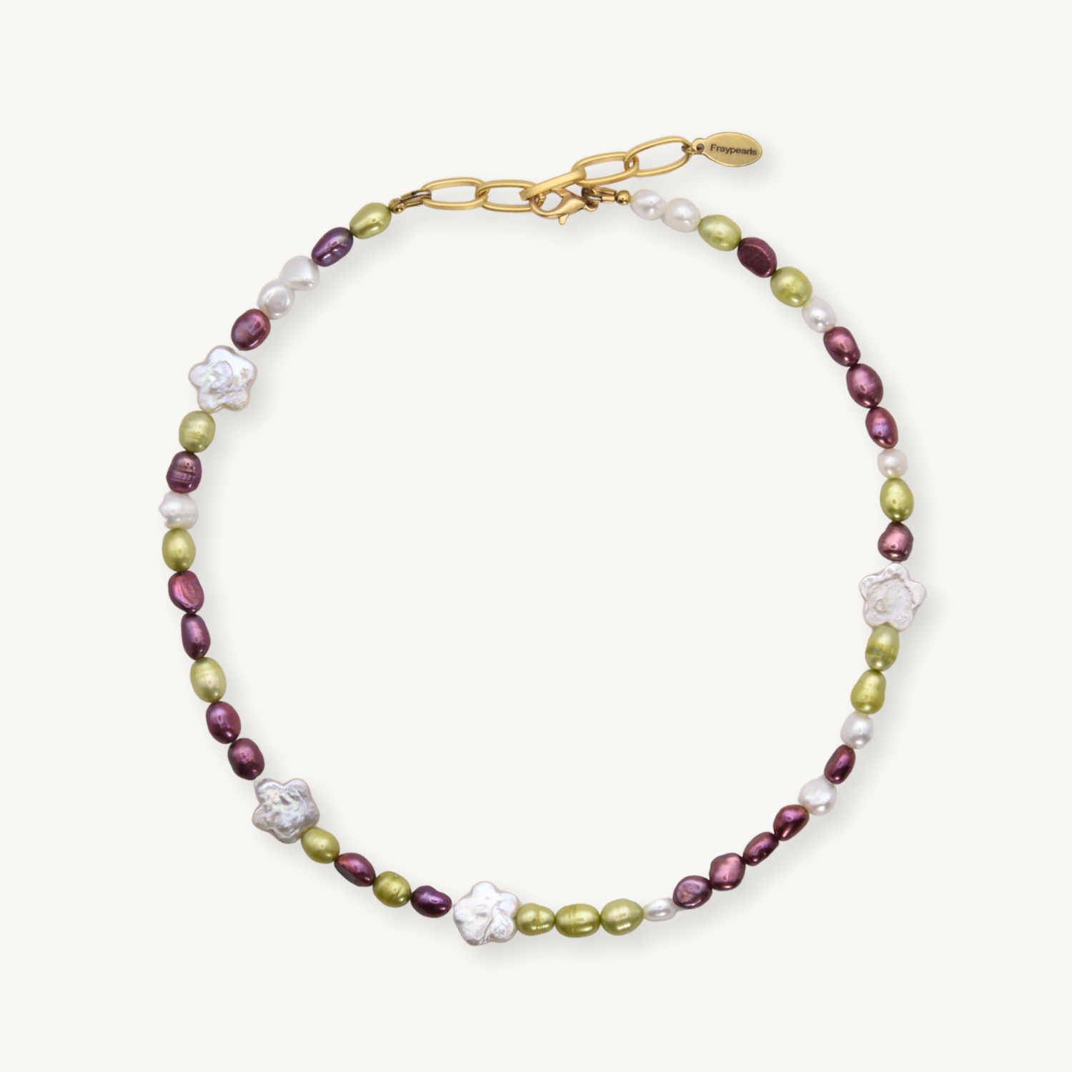Necklace with green and maroon round pearls with white flower shaped pearls on a white background