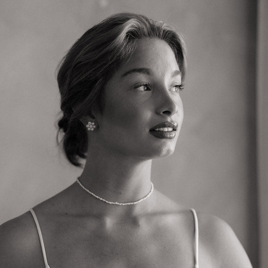 Black and white portrait of a woman wearing a necklace and earrings for wedding and bridal shower. 