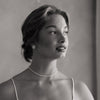 Black and white portrait of a woman wearing a necklace and earrings for wedding and bridal shower. 