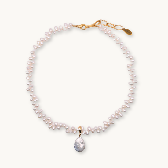 Pearl necklace with a gold clasp on a white background