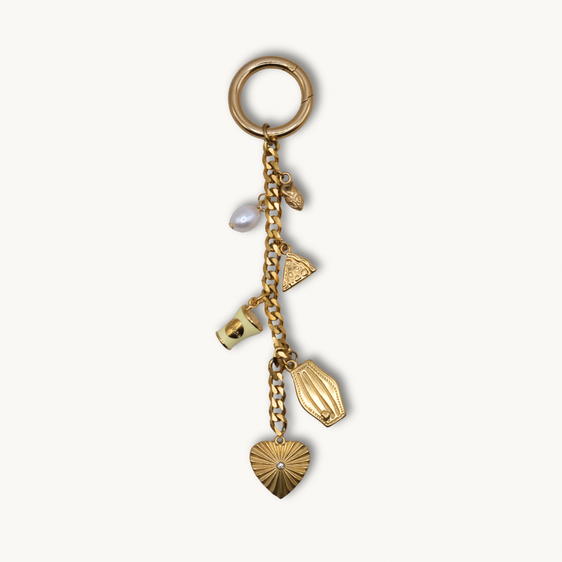 Gold keychain with various charms on a white background