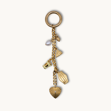 Gold keychain with various charms on a white background