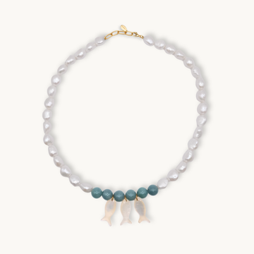 Pearl necklace with jade and gold clasps and pearl fish charms on a white background