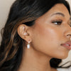 Bride wearing timeless pairing of diamond and pearl earrings.