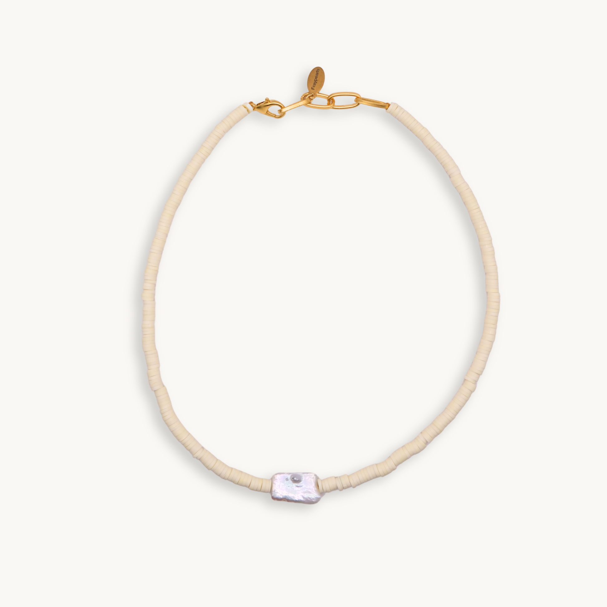 A soft and light yellow bead necklace featuring a single, irregularly-shaped gray pearl at the front. Gold clasp and chain links add a touch of elegance.