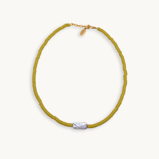 A warm green bead necklace featuring a single, irregularly-shaped gray pearl at the front. Gold clasp and chain links add a touch of elegance.