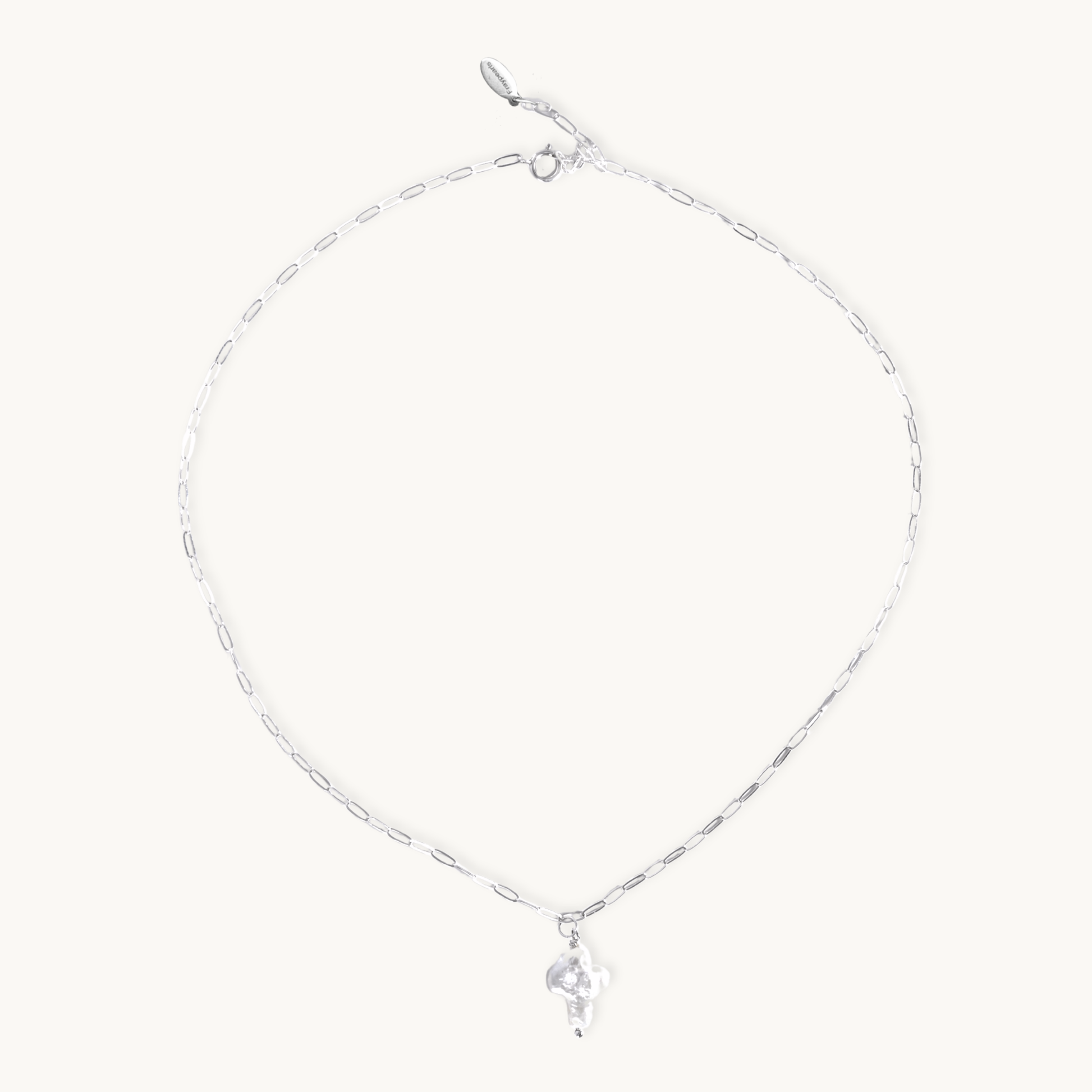 Silver necklace with a small pearl cross pendant on a white background