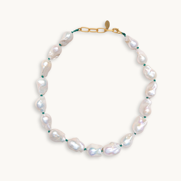 A baroque pearl necklace with irregular white pearls strung along a delicate green string. The lustrous pearls convey an elegant, natural look.