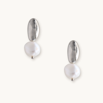 Silver and pearl drop earrings on a white background. Each earring features an irregular gold piece above a baroque pearl, giving an elegant, modern look.