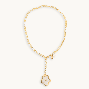 A gold chain necklace with a small flower pendant featuring a pearl inlay, displayed on a clean off-white background.