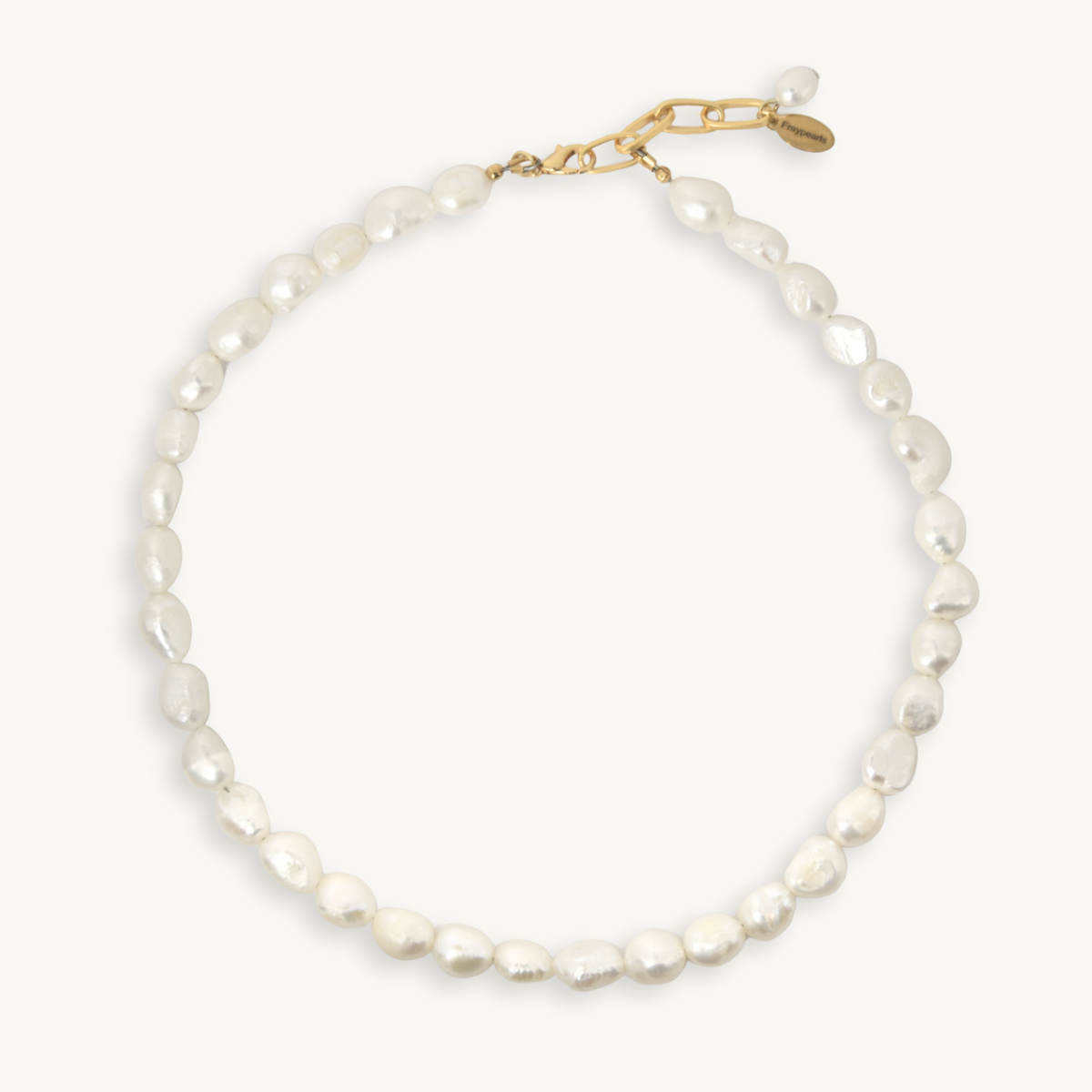 A baroque pearl necklace with a gold clasp, displayed on a clean off-white background.