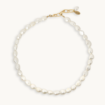 A baroque pearl necklace with a gold clasp, displayed on a clean off-white background.