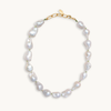 A baroque pearl necklace with irregular white pearls strung along a delicate green string. The lustrous pearls convey an elegant, natural look.