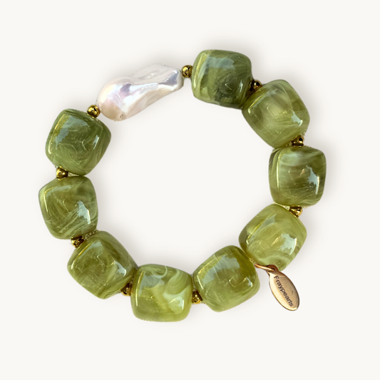 Green beaded bracelet with a gold clasp on a white background