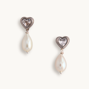 Silver heart earrings with clear cubic zirconia and dangling white teardrop pearls, 1 inch long.