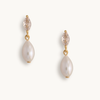 Pair of pearl drop earrings with gold accents on a white background