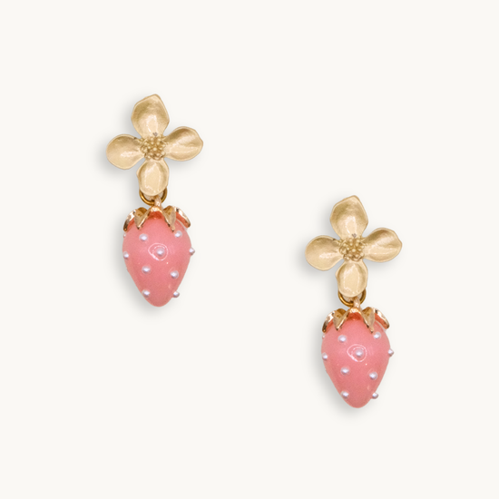 Gold flower earrings with pink strawberry charms featuring tiny pearl-like dots. The design is whimsical, delicate, and playful.