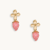 Gold flower earrings with pink strawberry charms featuring tiny pearl-like dots. The design is whimsical, delicate, and playful.