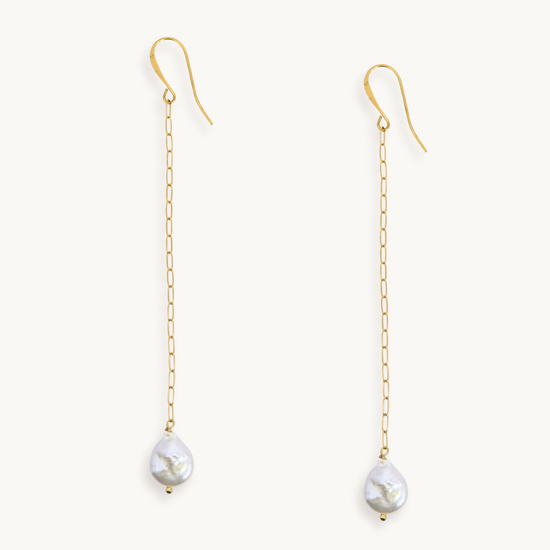 Long gold paperclip chain duster earrings with a baroque pearl drop.