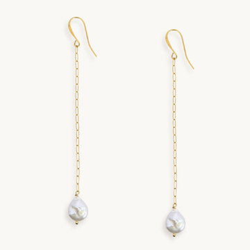 Long gold paperclip chain duster earrings with a baroque pearl drop.