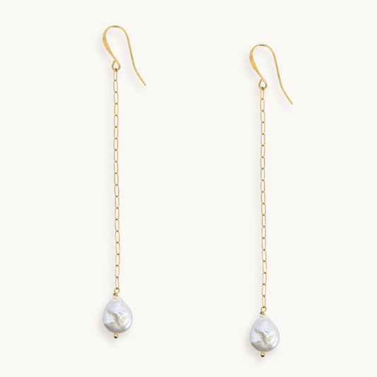 Long gold paperclip chain duster earrings with a baroque pearl drop.