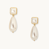 Elegant pearl drop earrings with gold trim, featuring a square pearl stud and teardrop pearl dangle. The design is classic and sophisticated.