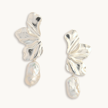 Silver earrings with leaf-like designs on a white background