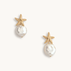 Pair of earrings with starfish and pearl design on a white background