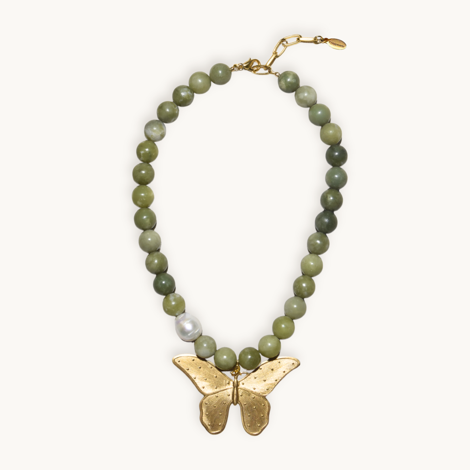 Necklace with round, green beads and a large gold butterfly pendant at the center. The beads vary in shade, and there's a single white pearl accent.