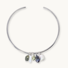 A silver-toned open hoop necklace with five dangling baroque pearl charms in various colors, displayed on a clean off-white background.