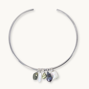 A silver-toned open hoop necklace with five dangling baroque pearl charms in various colors, displayed on a clean off-white background.