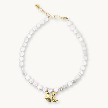 Freshwater coin pearl necklace with a gold bikini top and bottom charm and a gold hook clasp.