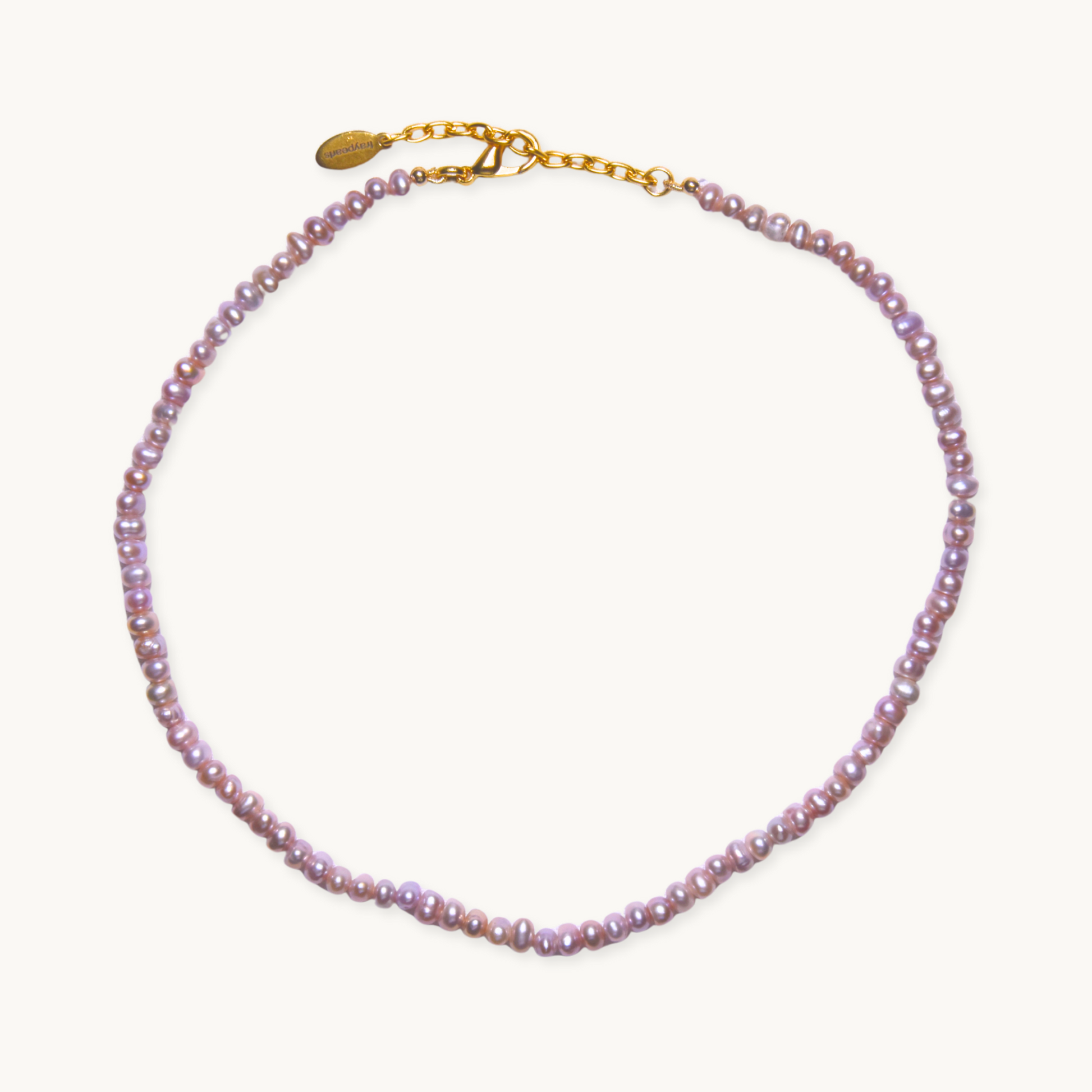 A delicate necklace featuring small, lustrous pink pearls strung along its length, with a gold chain and clasp, set against a plain white background.
