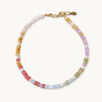A colorful beaded necklace with pastel pink, yellow, green, and blue beads, interspersed with white pearls. It has a gold chain and clasp.