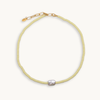 Light yellow beaded necklace with a pearl pendant on a white background