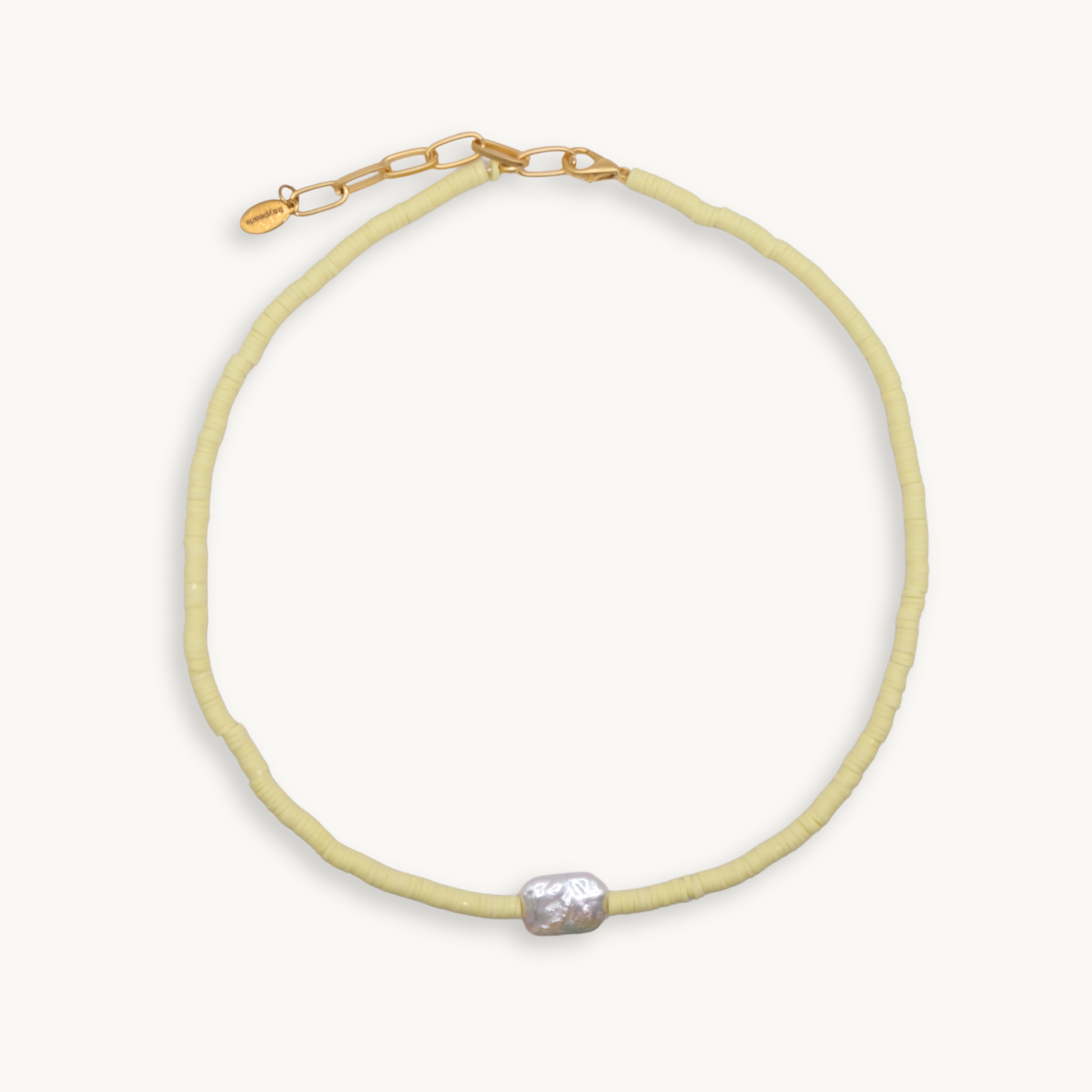 Light yellow beaded necklace with a pearl pendant on a white background