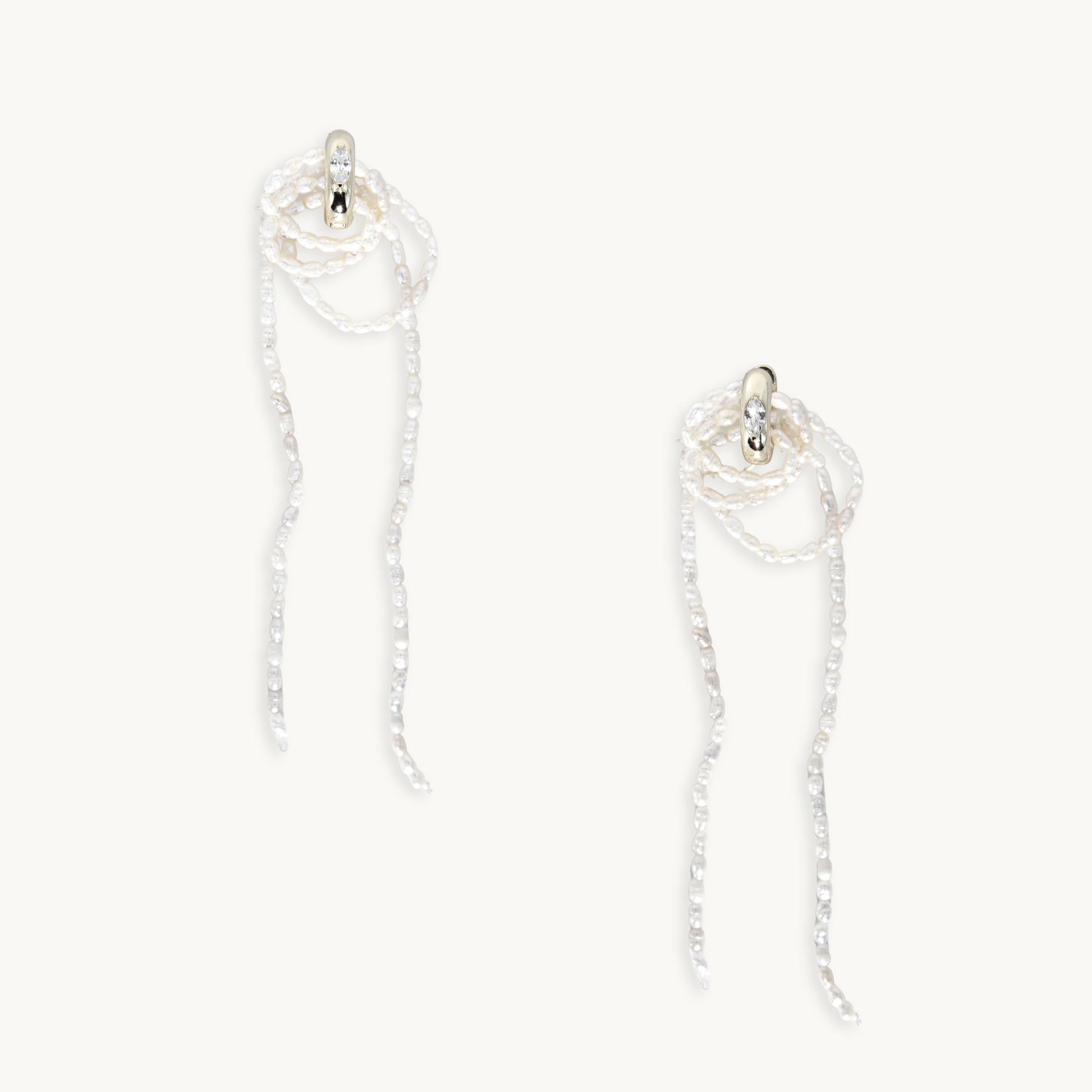 Elegant pearl earrings with silver hoops and long, flowing strands. The design is delicate, exuding sophistication and maximalist charm.